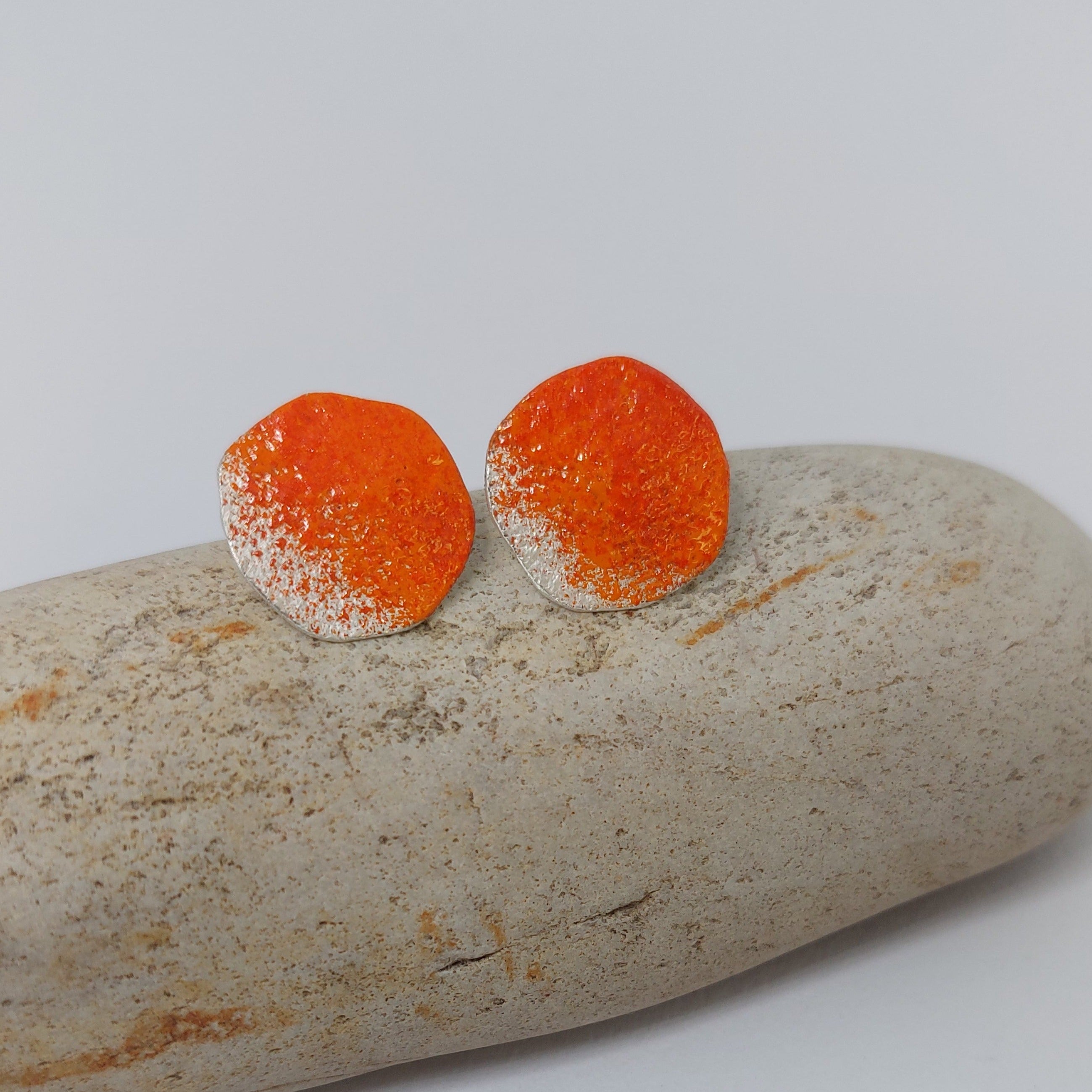 strerling silver stud earrings in organic shape with bright orange powder coat.