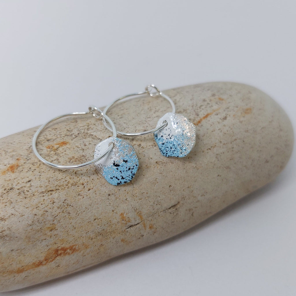 Sterling silver hoop earrings with powder coated colours in blue, white and black to portray lichens.