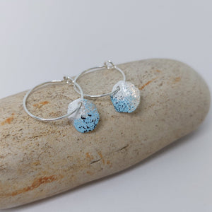 Sterling silver hoop earrings with powder coated colours in blue, white and black to portray lichens.