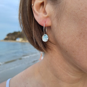 Sterling silver hoop earrings with powder coated colours in blue, white and black to portray lichens.