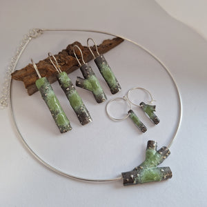 Oxidised sterling silver jewellery pieces with powdercoated lichens.