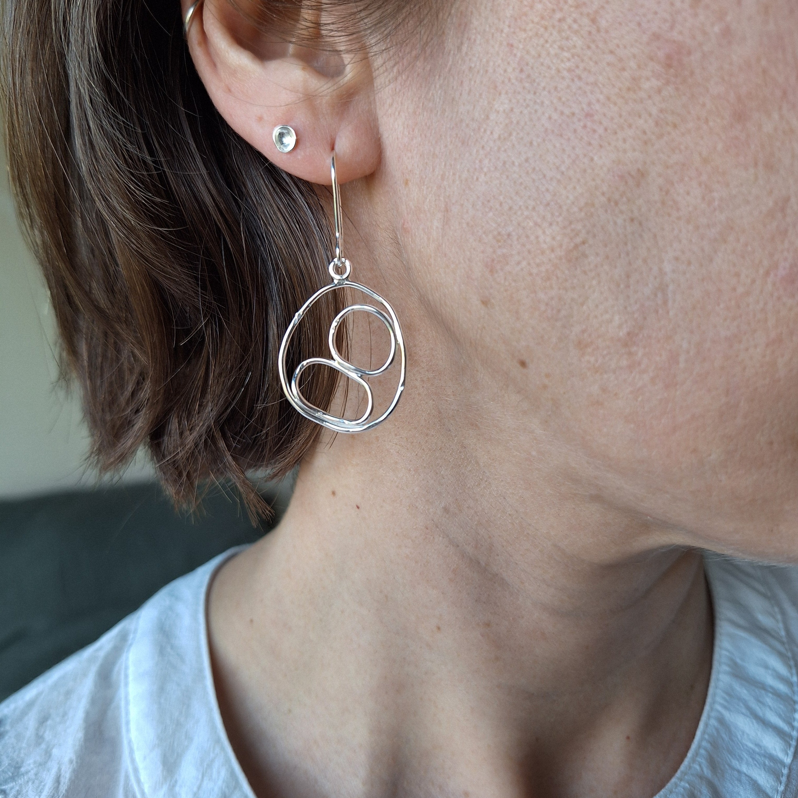 Sterling Silver Beach Boulder shape earring in sterling silver on ear.