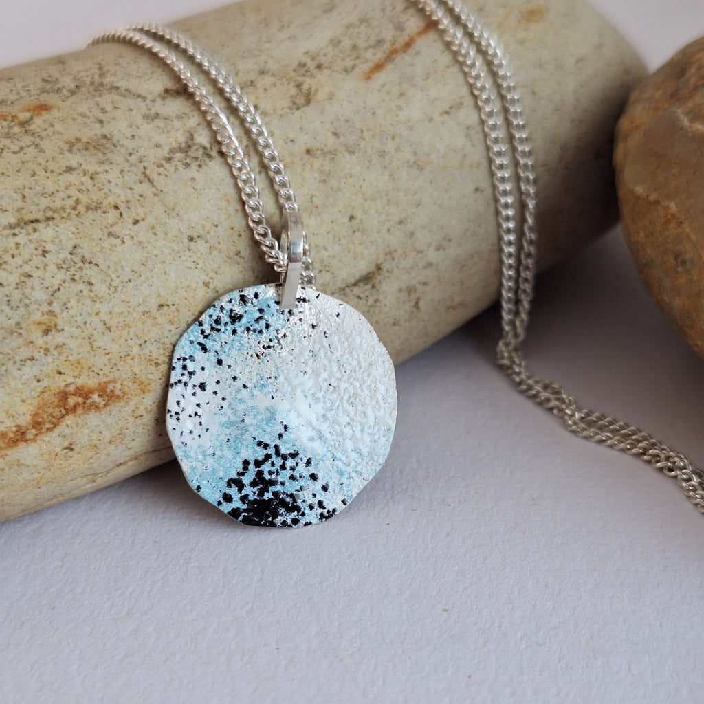 Sterling silver beach rock lichen necklace with blue, white and black powder coat on an adjustable sterling silver chain. Handmade in Tasmania by Karen Visagie from Hulley Jewellery