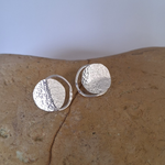Load image into Gallery viewer, Sterling silver Tasmanian each boulder inspired stud earrings on a rock.
