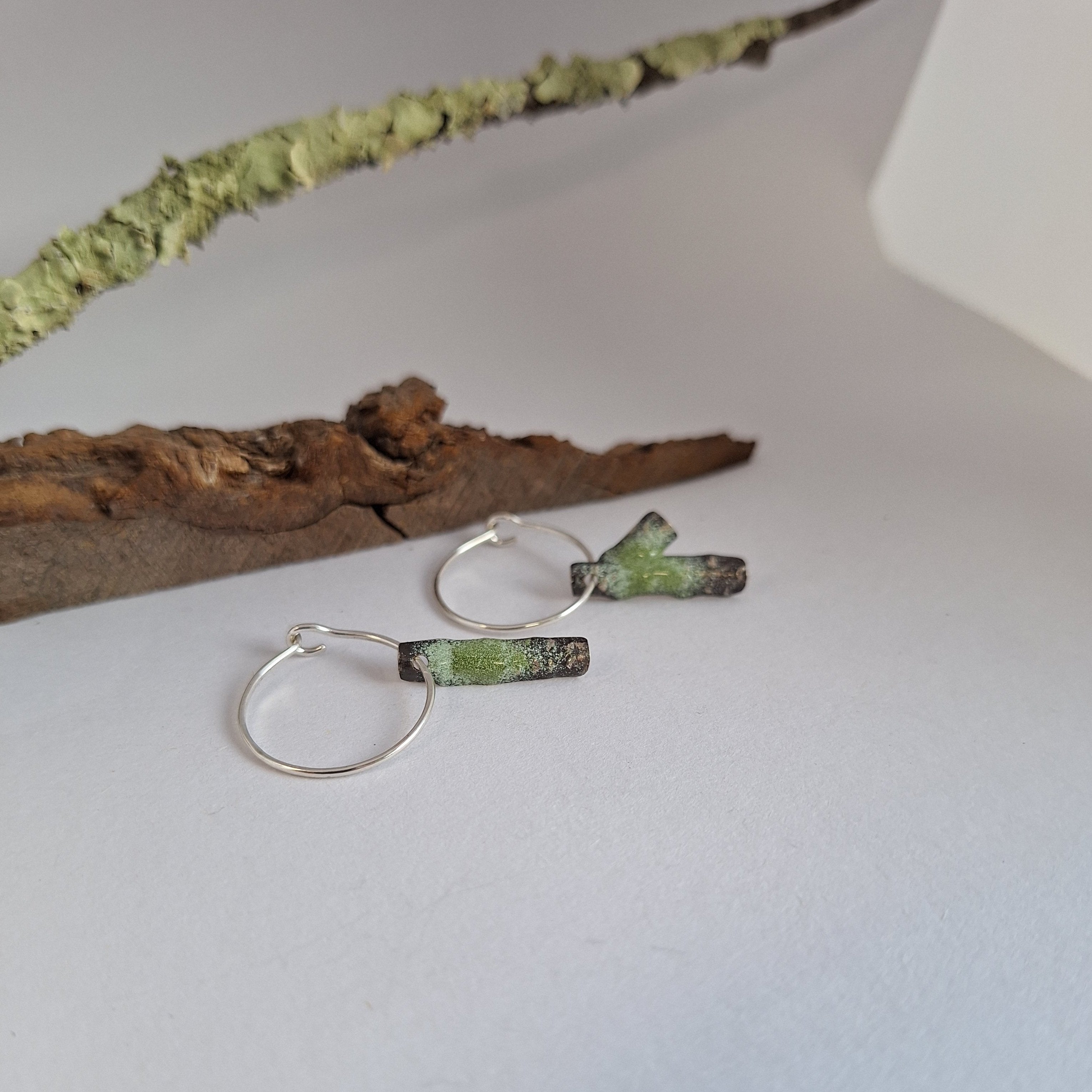 Frosted or blackened sterling silver hoop earrings with domed lichen cup or green powder coated details inspired by lichens on forest trees. Handmade in Tasmania by Karen Visagie from Hulley Jewellery