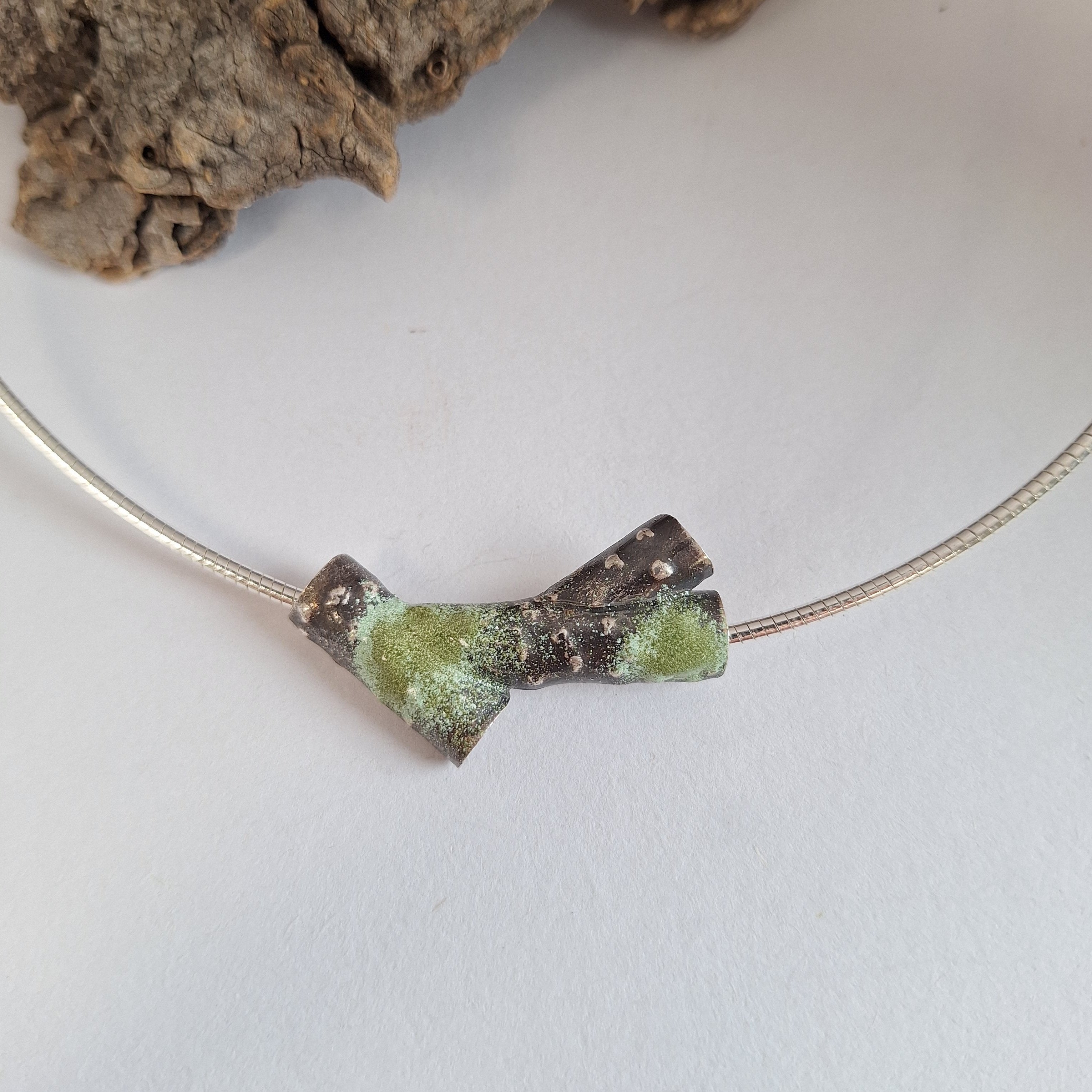 Oxidised blackened sterling silver forest lichen inspired necklace on a extendable omega chain with bark texture and green powder coated lichens