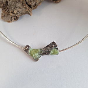 Oxidised blackened sterling silver forest lichen inspired necklace on a extendable omega chain with bark texture and green powder coated lichens