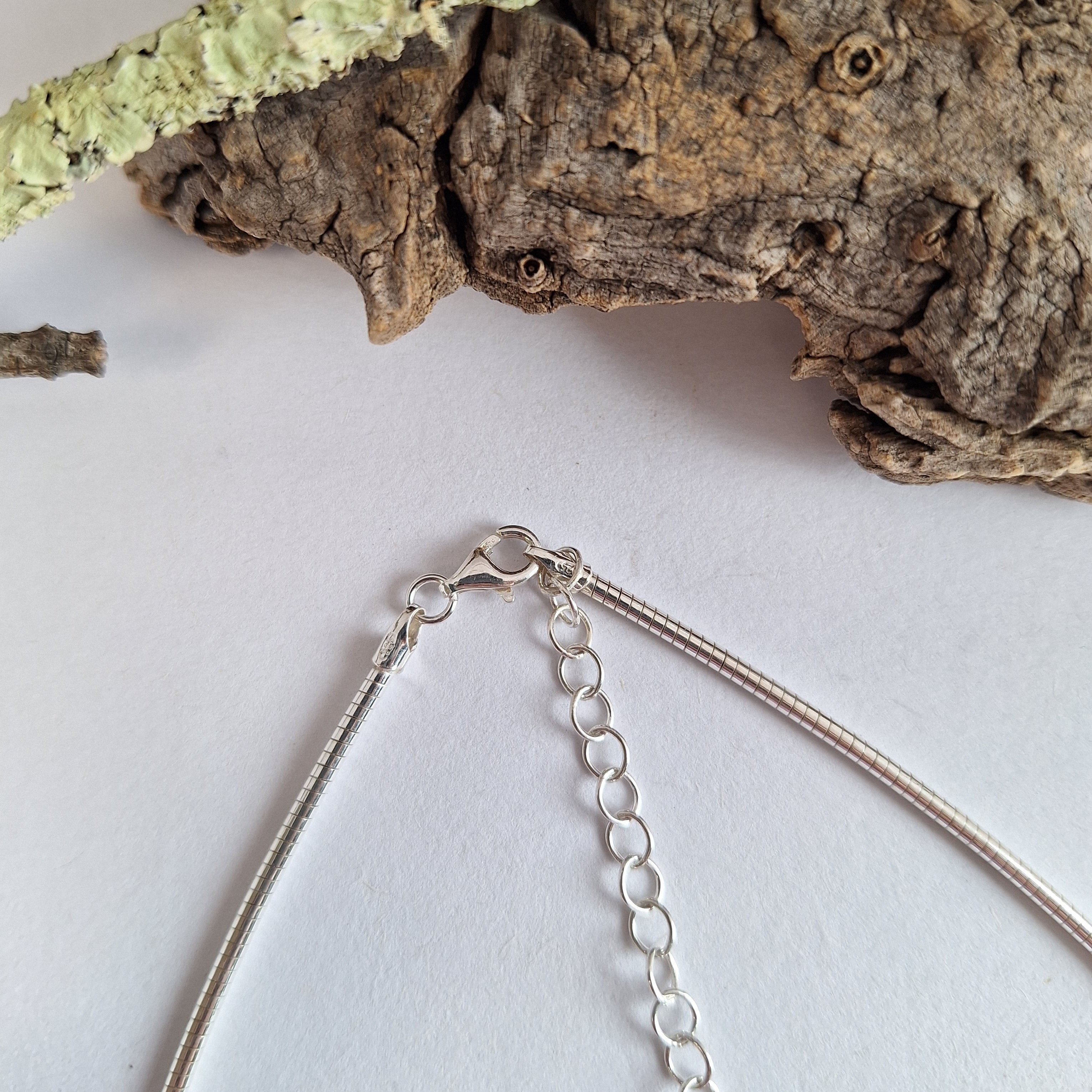 Sterling silver forest lichen inspired necklace on a extendable omega chain with bark texture and green powder coated lichens