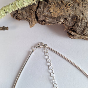 Sterling silver forest lichen inspired necklace on a extendable omega chain with bark texture and green powder coated lichens