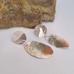 Load image into Gallery viewer, Sterling silver earrings with powder coat lichen on white background with rock in background
