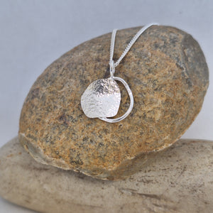 Sterling silver organic shape beach boulder inspired necklace on neck. Handmade in Tasmania by Karen Visagie from Hulley Jewellery 