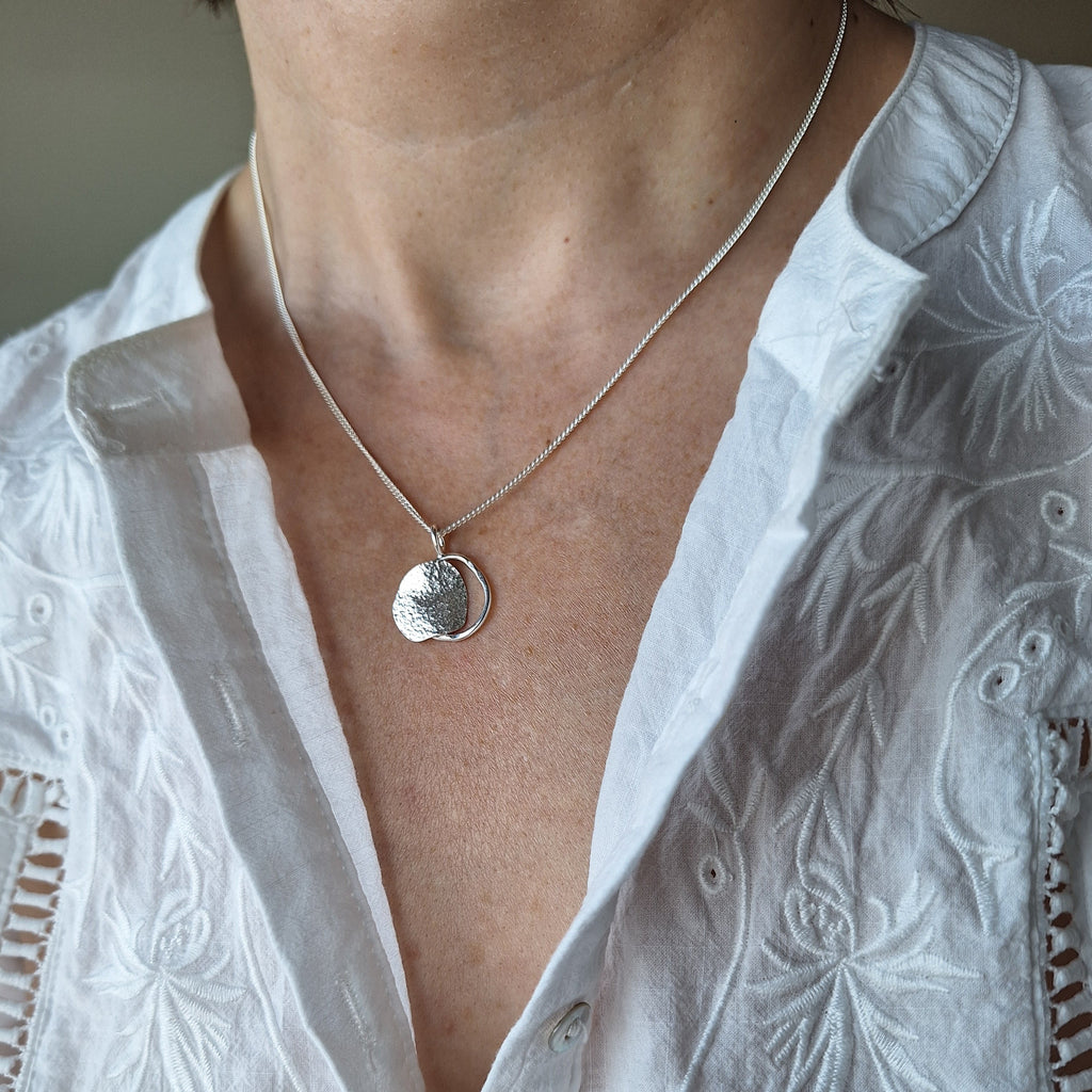 Sterling silver organic shape beach boulder inspired necklace on neck. Handmade in Tasmania by Karen Visagie from Hulley Jewellery 
