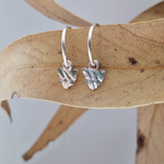 Load image into Gallery viewer, Sterling Silver Tasmania hoop earrings pictured on a leaf handmade in Tasmania in small batches.
