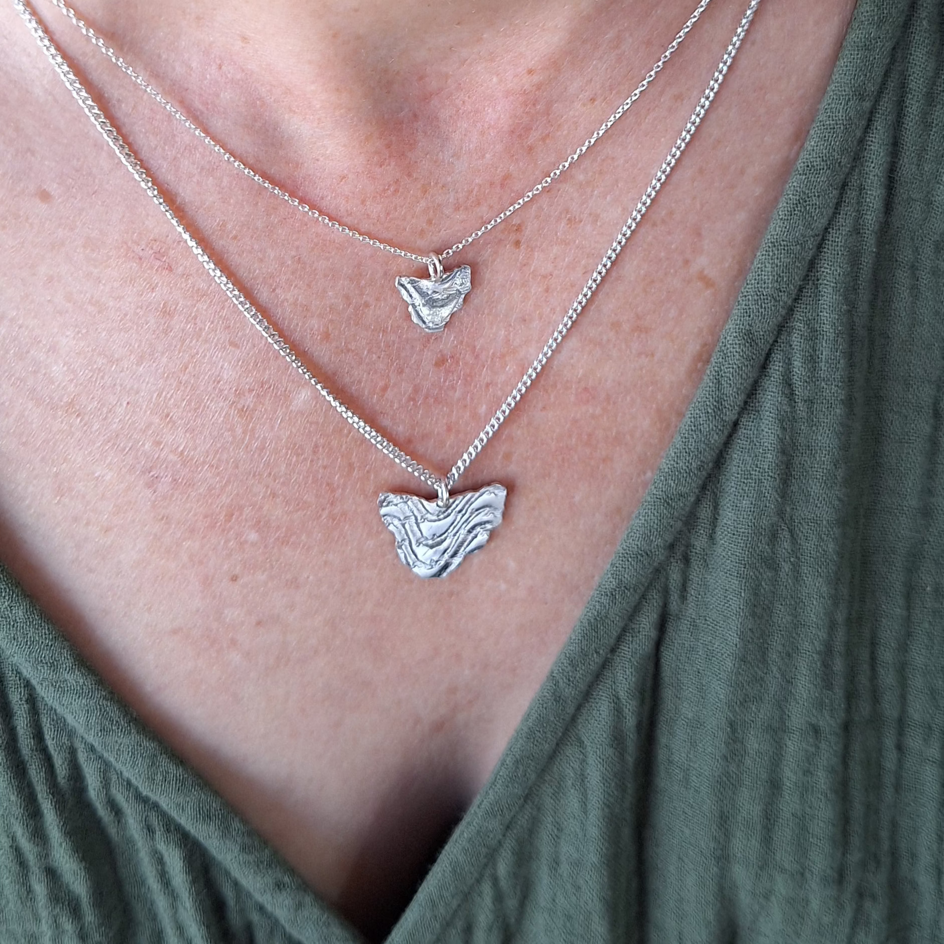 Small and Large Tassie necklace on neck.