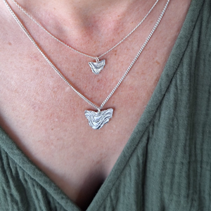 Small and Large Tassie necklace on neck.