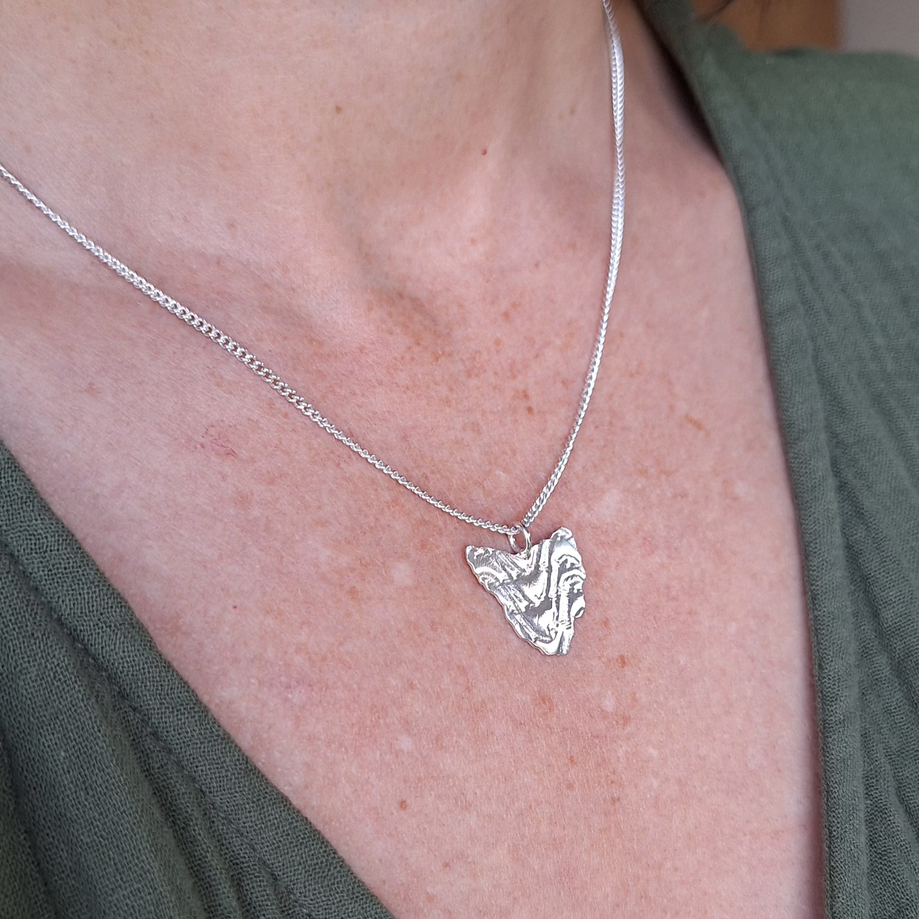 Sterling silver handmade necklace in the shape of Tasmania with contour line texture. Map necklace of Tasmania on a adjustable sterling silver chain.