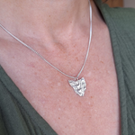 Load image into Gallery viewer, Sterling silver handmade necklace in the shape of Tasmania with contour line texture. Map necklace of Tasmania on a adjustable sterling silver chain.
